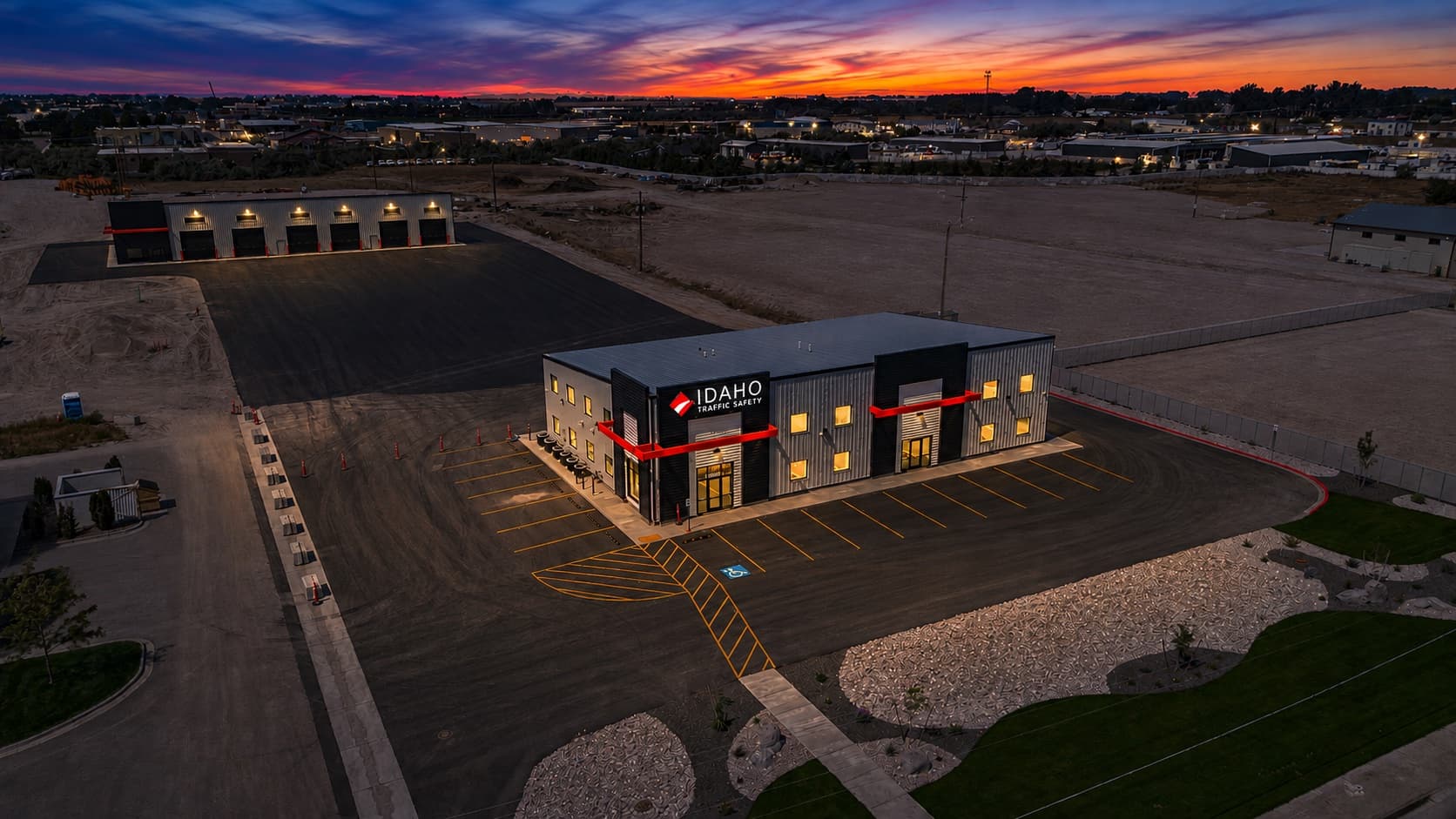 Aerial view at twilight of Idaho Traffic Safety's headquarters, shop, and yard at 2467 N Holmes Ave in Idaho Falls